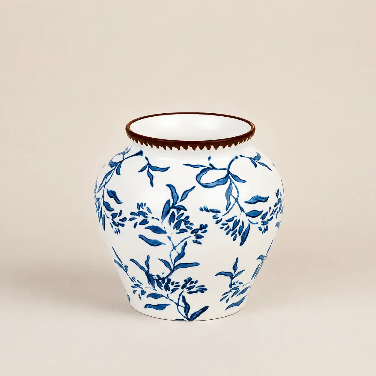 Fleur de Lis ceramic vase featuring hand-painted blue floral patterns.