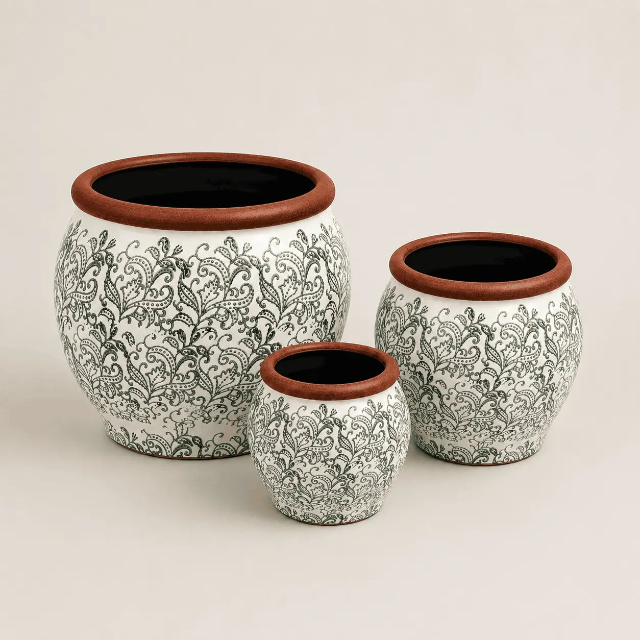 Fleur de Lis ceramic planter set with green paisley patterns and terracotta rims.