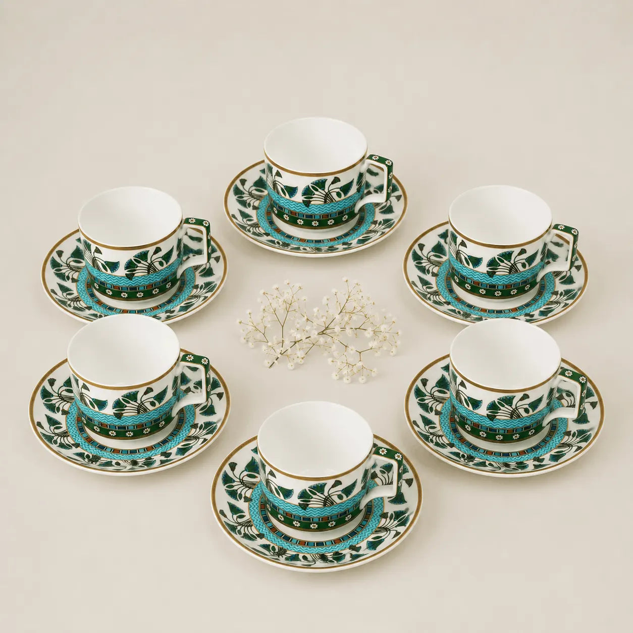 Luxury porcelain tea cup and saucer set with floral motifs and gold detailing.