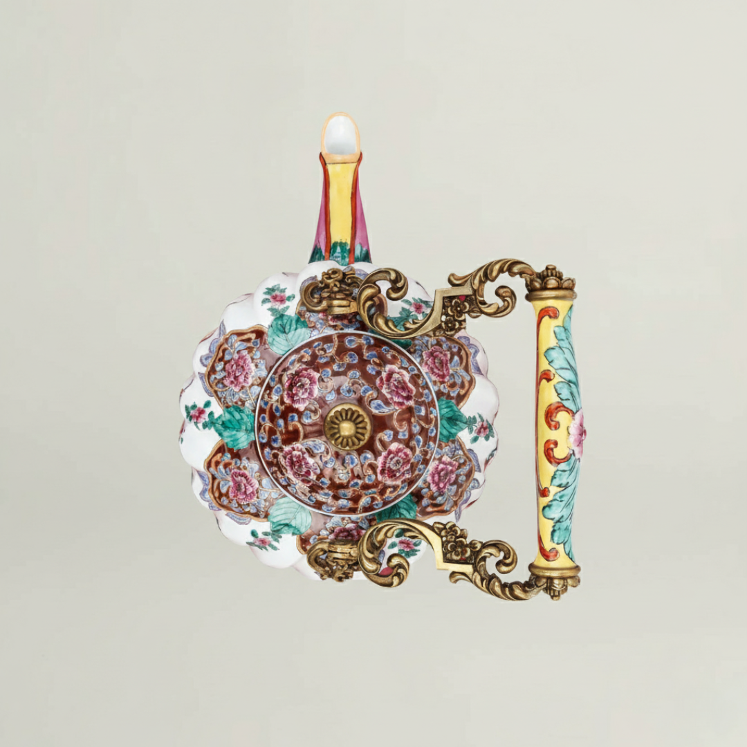 Top view of an ornate ceramic teapot showcasing detailed floral lid design, sculpted spout, and decorative gold-accented handle.
