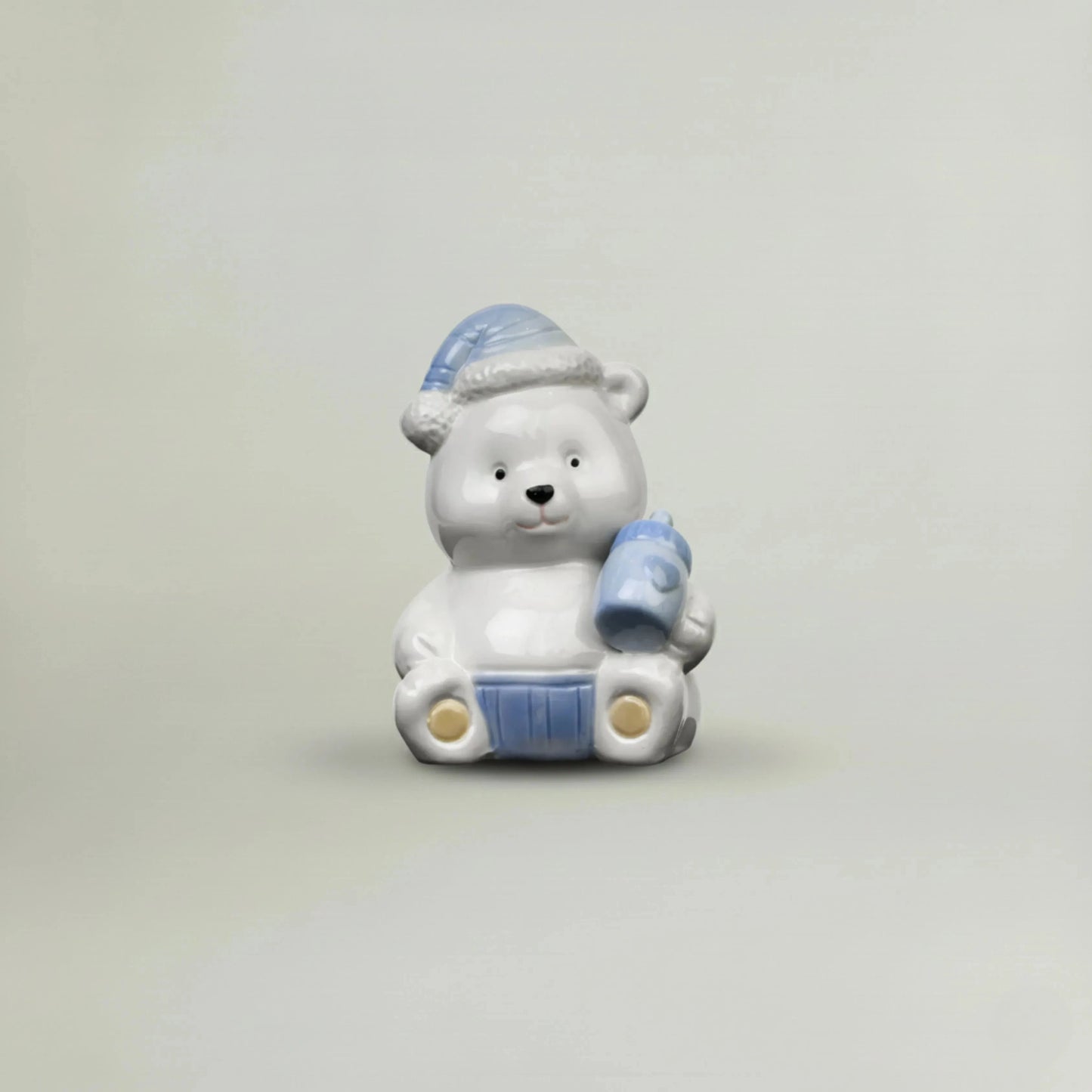 Blue ceramic baby teddy bear figurine with pastel nightcap and baby bottle, glossy nursery decor keepsake gift for newborn baby shower