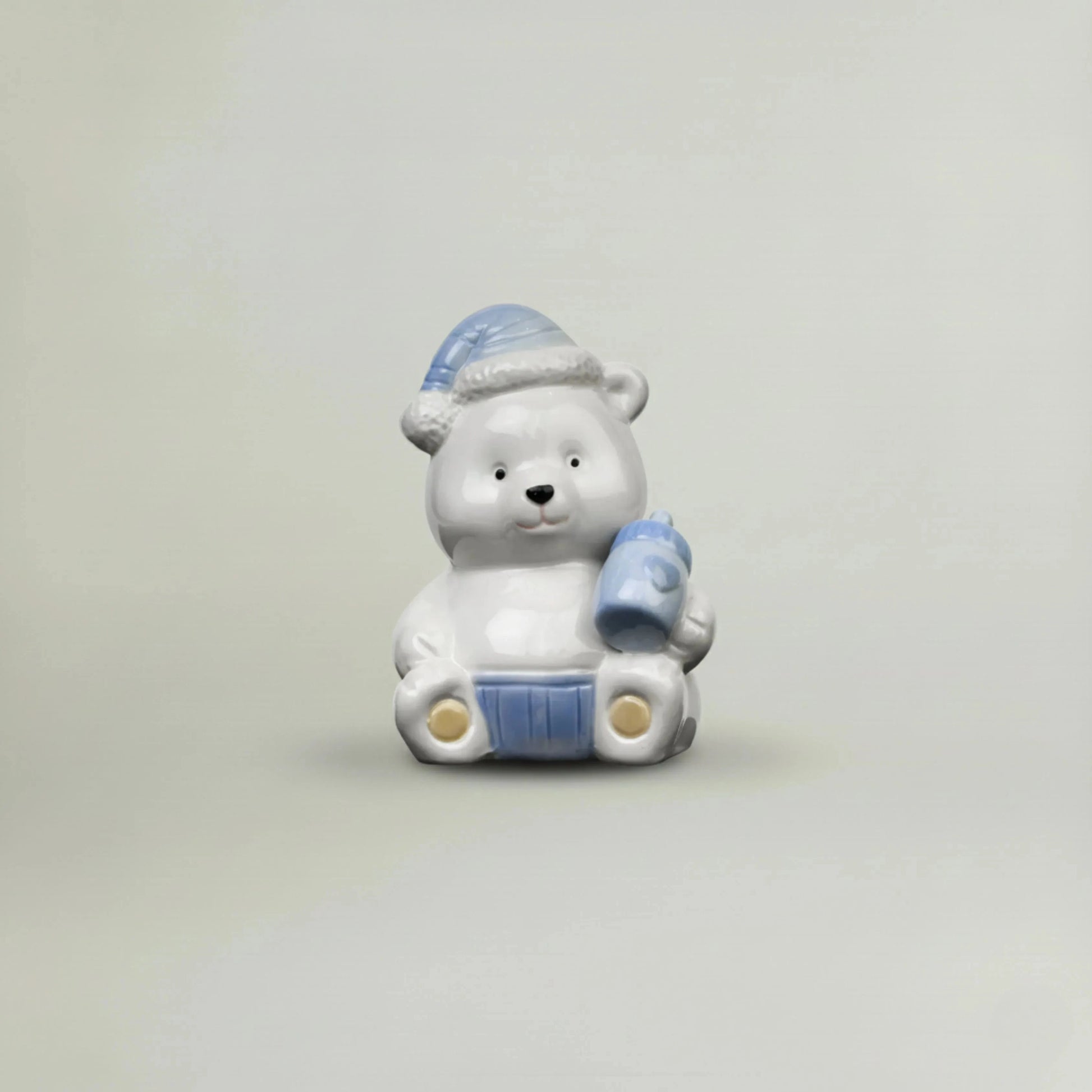 Blue ceramic baby teddy bear figurine with pastel nightcap and baby bottle, glossy nursery decor keepsake gift for newborn baby shower