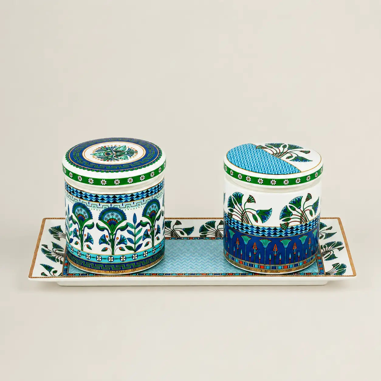 Two premium decorative ceramic canisters placed neatly on a matching long rectangular serving tray.