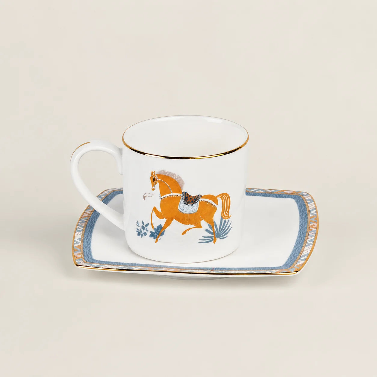 Porcelain cup and saucer set with equestrian horse motif and gold rim.