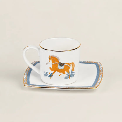Porcelain cup and saucer set with equestrian horse motif and gold rim.