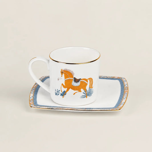 Porcelain cup and saucer set with equestrian horse motif and gold rim.