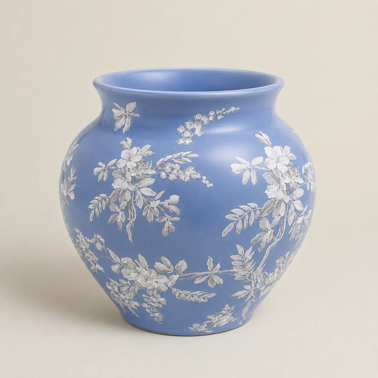 Fleur de Lis blue ceramic vase with delicate white floral detailing.