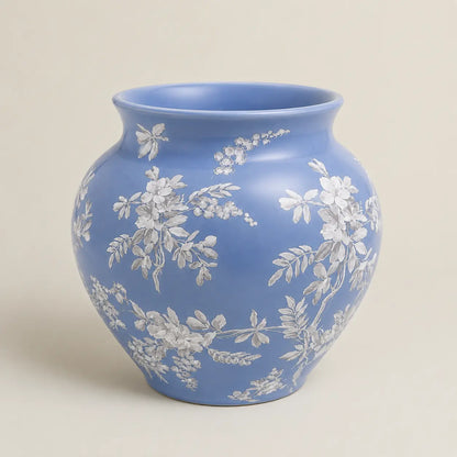 Fleur de Lis blue ceramic vase with delicate white floral detailing.