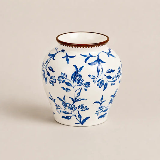 Fleur de Lis white porcelain vase with blue floral botanical motifs.