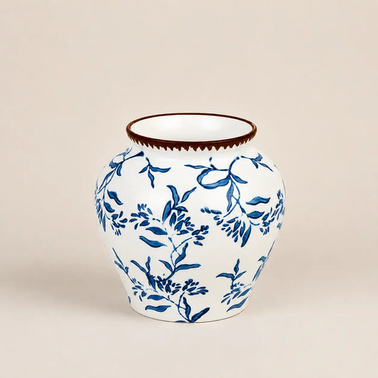 Fleur de Lis ceramic vase featuring hand-painted blue floral patterns.