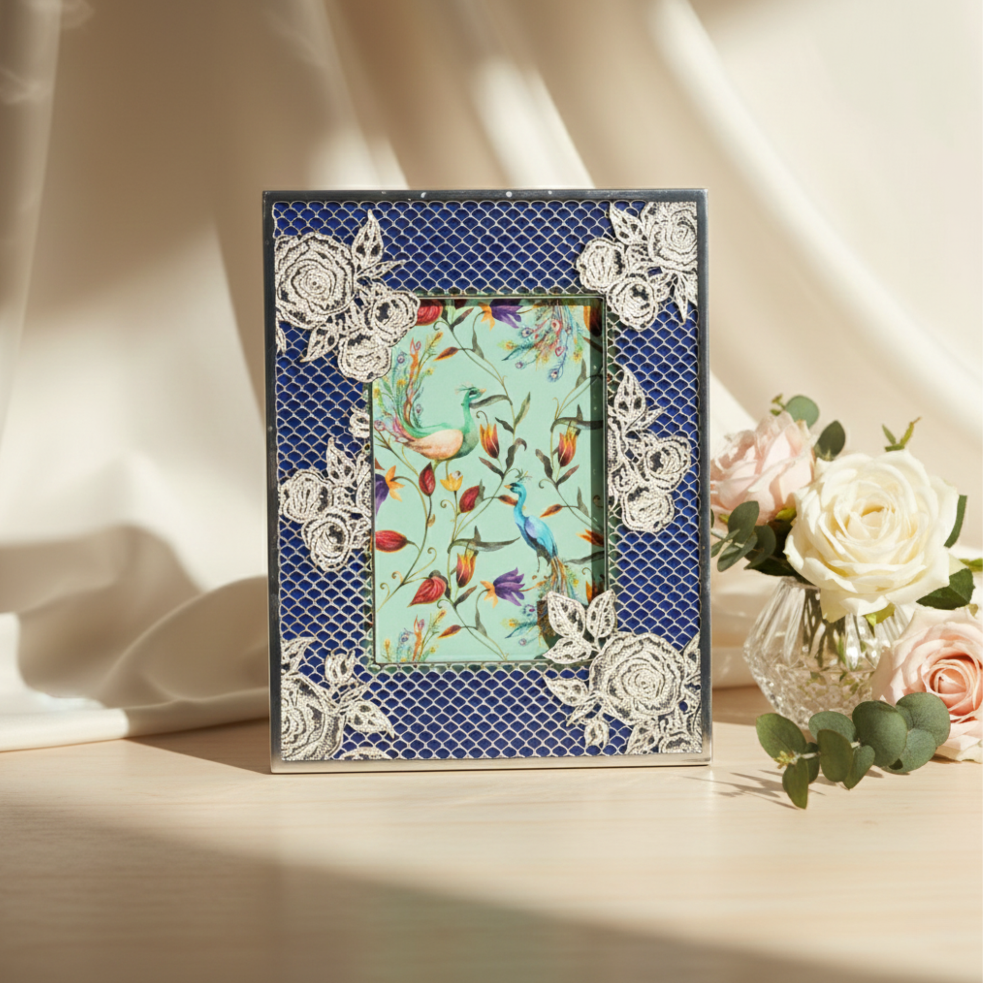 Ornate Fleur de Lis decorative photo frame with floral detailing, styled with soft florals as part of a luxury gifting collection.