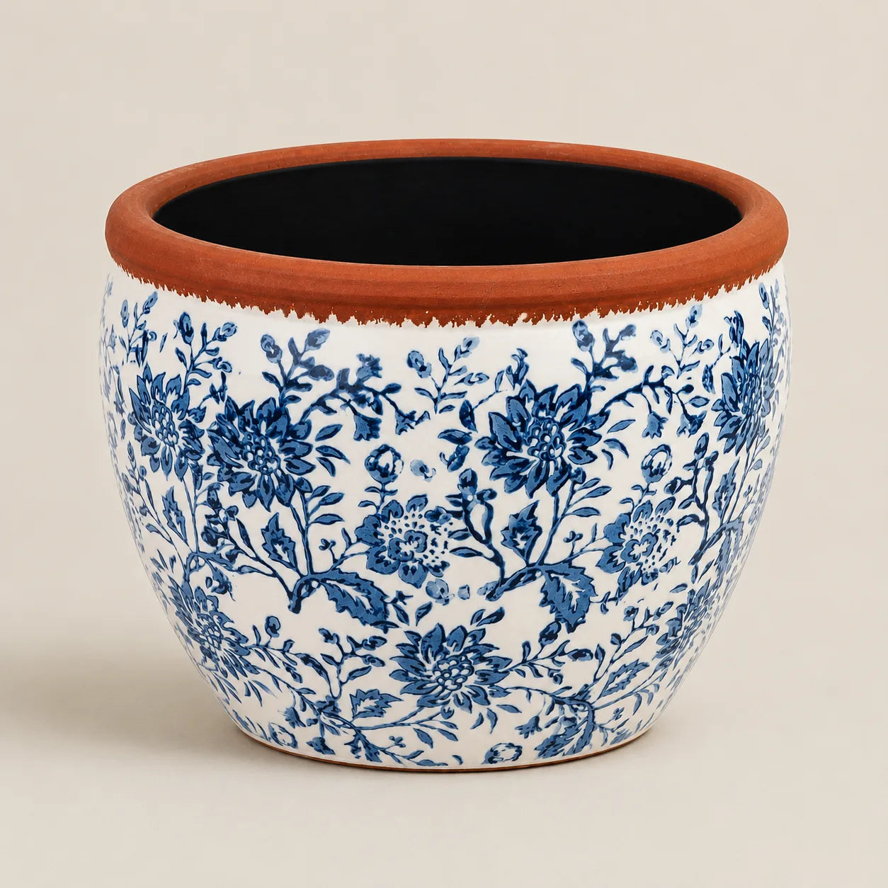 Large decorative ceramic planter with blue botanical artwork and terracotta finish.