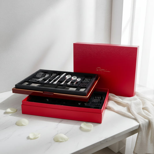 Sottile luxury 84-piece cutlery set by Fleur De Lis styled for refined dining, showcasing premium stainless steel flatware in an elegant red presentation box.
