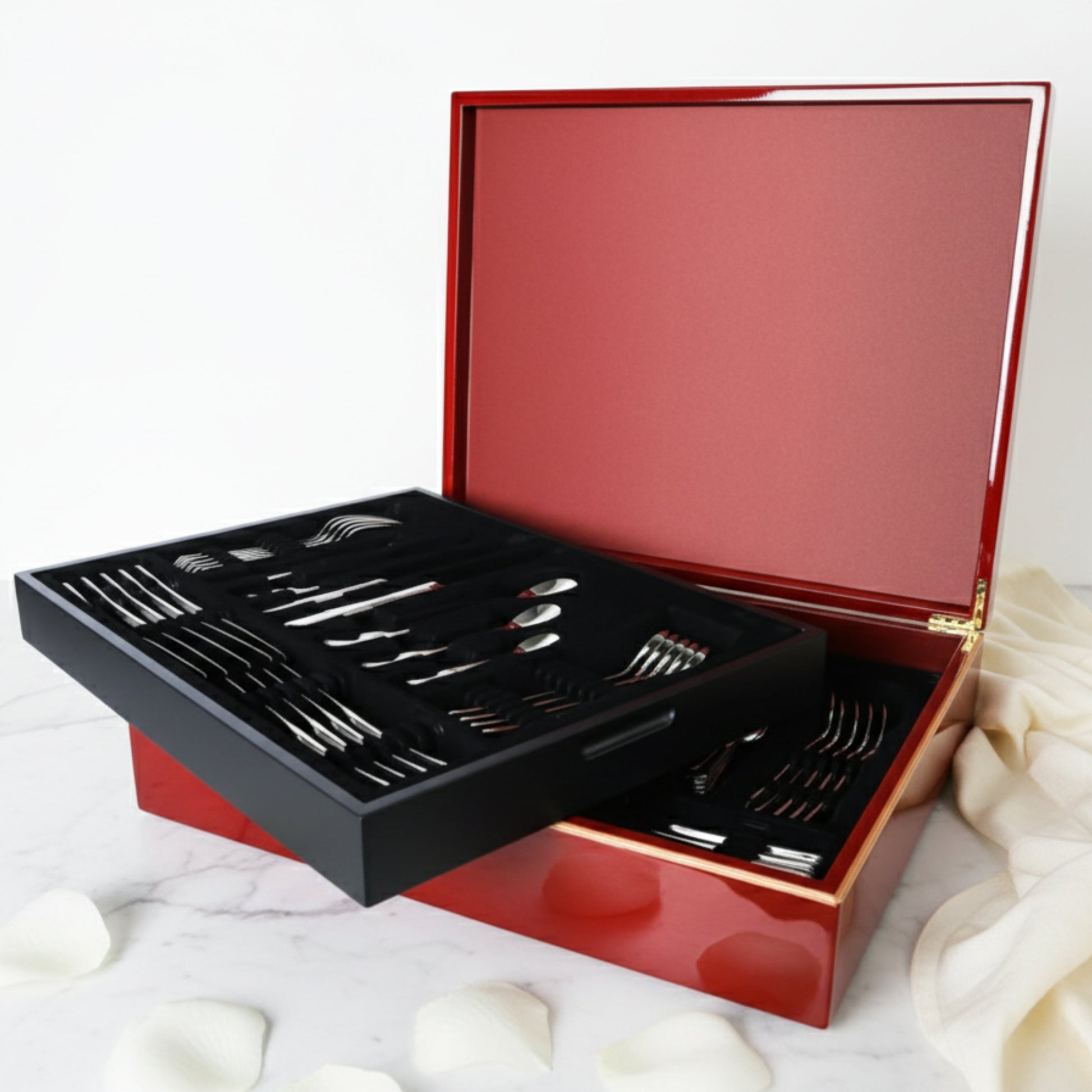 Sottile luxury 84-piece cutlery set by Fleur De Lis styled for refined dining, showcasing elegant stainless steel flatware in a wooden presentation box.