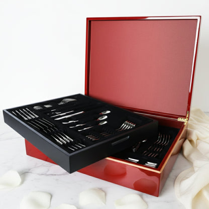 Sottile luxury 84-piece cutlery set by Fleur De Lis styled for refined dining, showcasing elegant stainless steel flatware in a wooden presentation box.