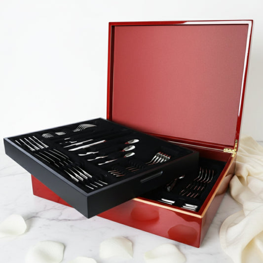 Sottile luxury 84-piece cutlery set by Fleur De Lis styled for refined dining, showcasing elegant stainless steel flatware in a wooden presentation box.