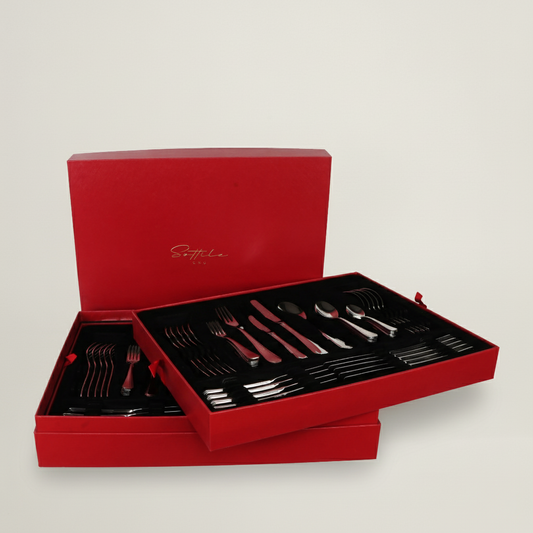 Sottile 84-piece luxury stainless steel cutlery set by Fleur De Lis presented in a premium red gift box with mirror-polished flatware.