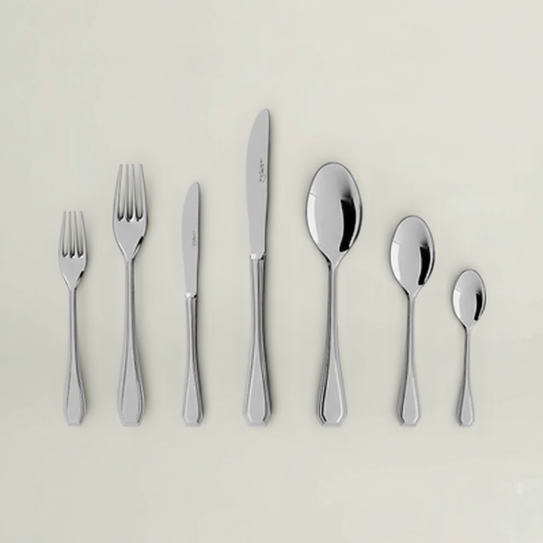 Complete Sottile 84-piece stainless steel flatware collection by Fleur De Lis, including forks, knives, spoons, teaspoons, and serving pieces.