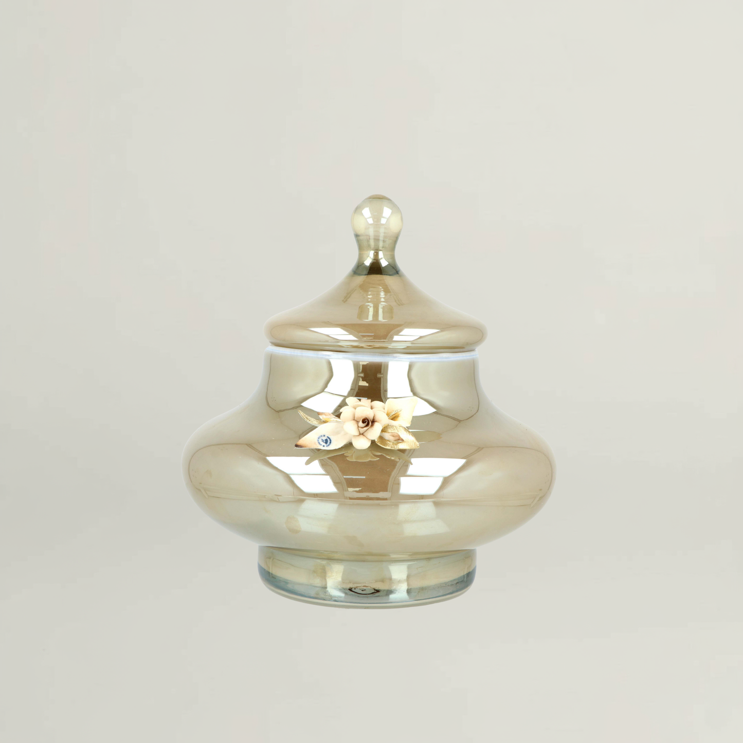 Splendor luxury amber floral decorative jar by Fleur De Lis with smooth rounded form, reflective glass finish, and sculpted floral accent.