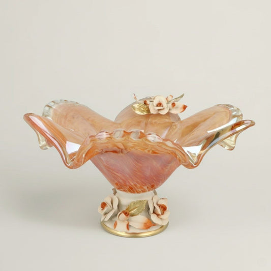 Tangerine Ripple amber glass decorative centerpiece bowl by Fleur De Lis with ruffled edges, warm orange tones, and floral pedestal base.