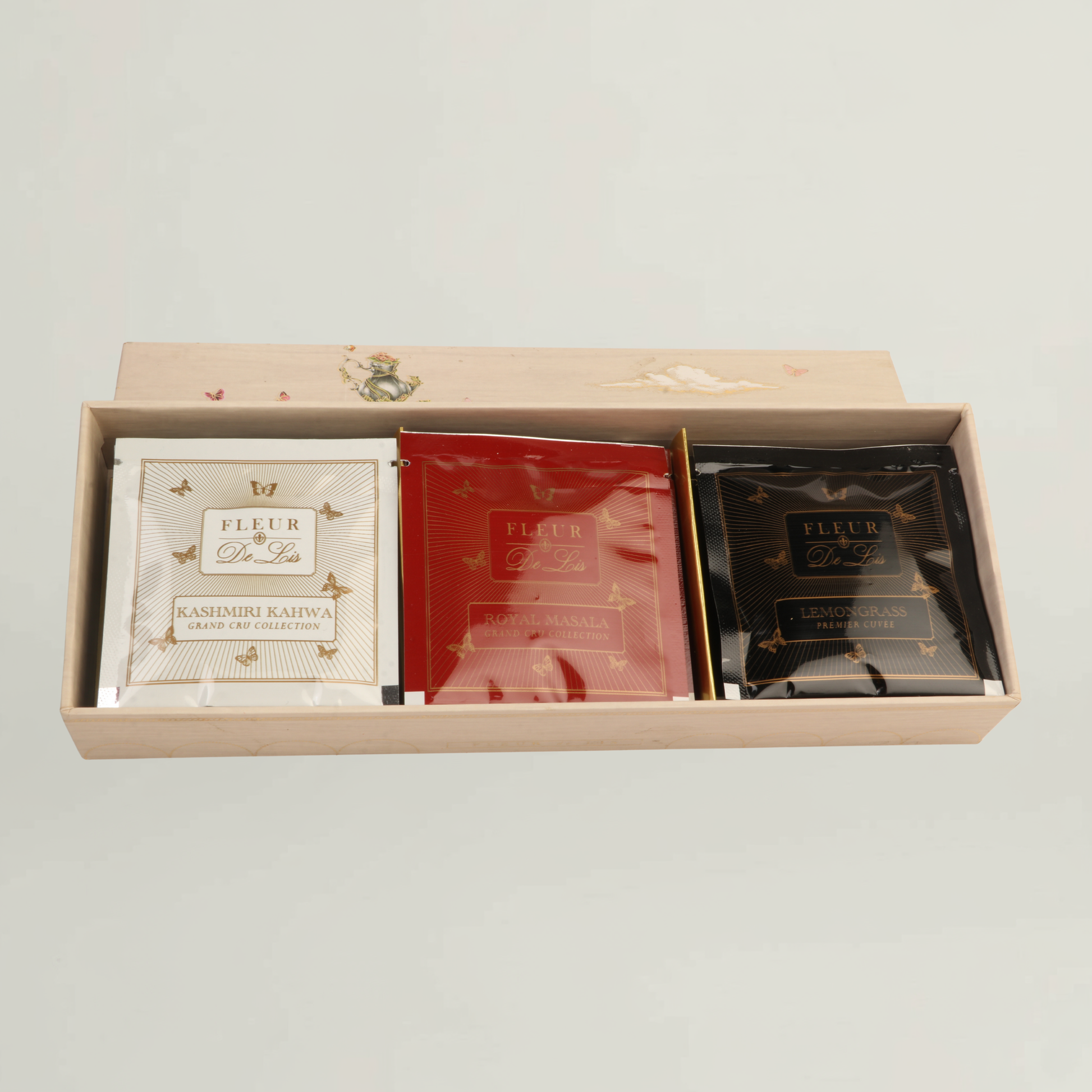 Fleur de Lis luxury tea assortment box featuring Kashmiri Kahwa, Royal Masala, and Lemongrass blends in premium packaging.