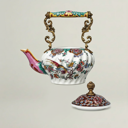 Hand-painted ceramic teapot featuring intricate floral artwork, sculpted spout, and removable decorative lid with gold finial.