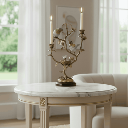 Decorative bird candle stand with branching gold design and twin candles, styled on a marble table for refined luxury home décor.