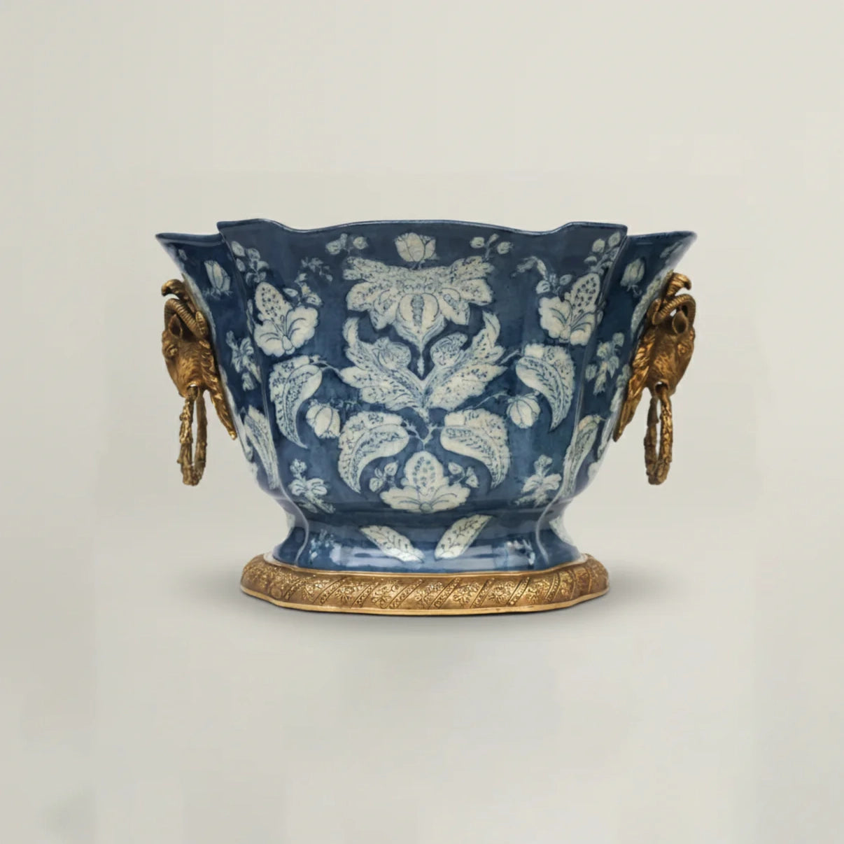 Luxury blue ceramic decorative bowl with intricate floral pattern, antique gold handles, and pedestal base for elegant home décor.
