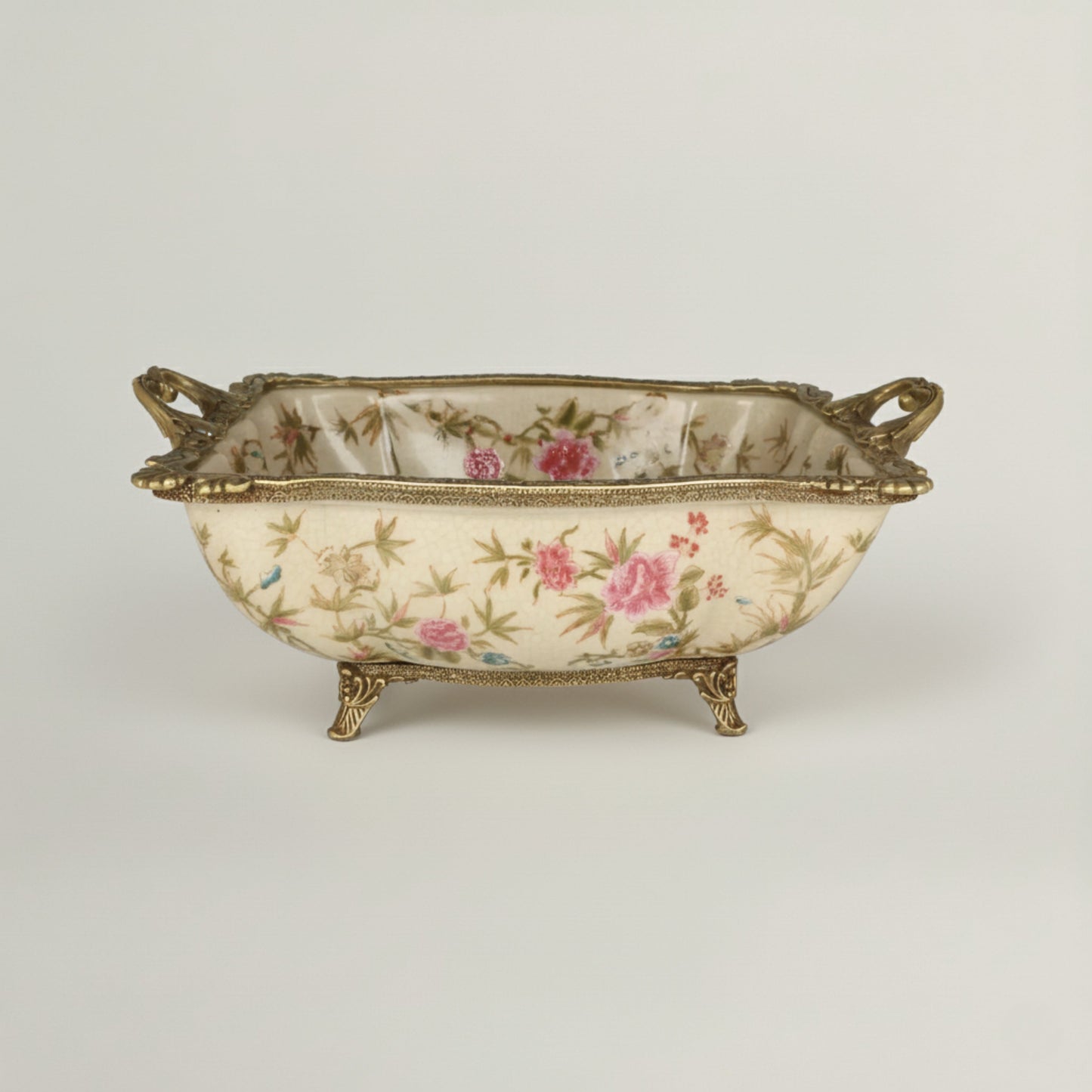 Luxury ceramic decorative bowl with hand-painted floral motifs, antique gold handles, and raised feet, ideal for elegant home décor.