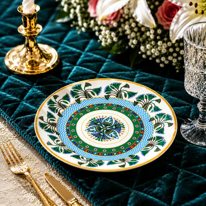 Intricately designed porcelain salad plate featuring a bright blue chevron inner ring and botanical border.