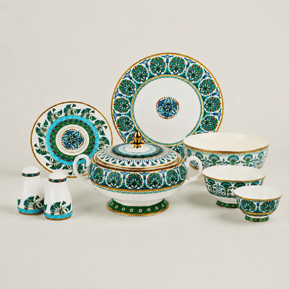 A complete luxury porcelain dinnerware collection including plates, bowls, shakers, and a tureen on a clean background.