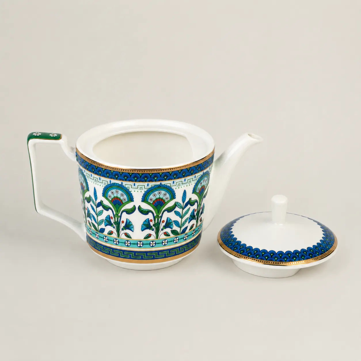 Elegant porcelain teapot with lid, floral motifs and gold accents.