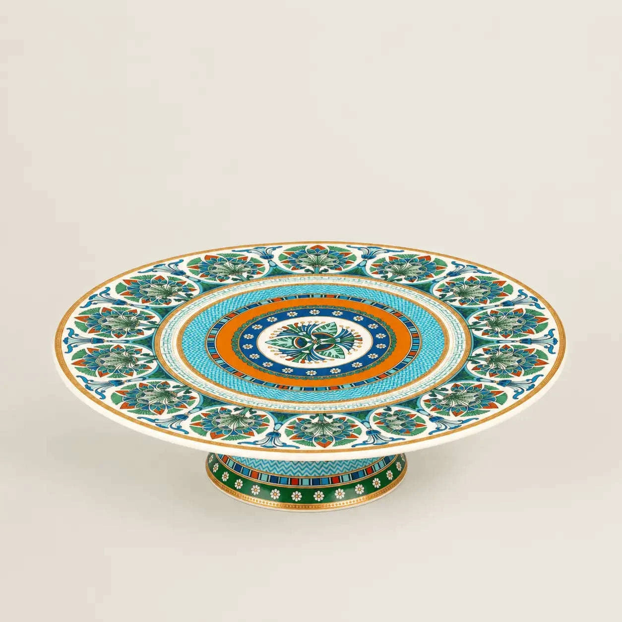 Luxury Mediterranean porcelain pedestal cake stand with intricate floral motifs and gold accents.