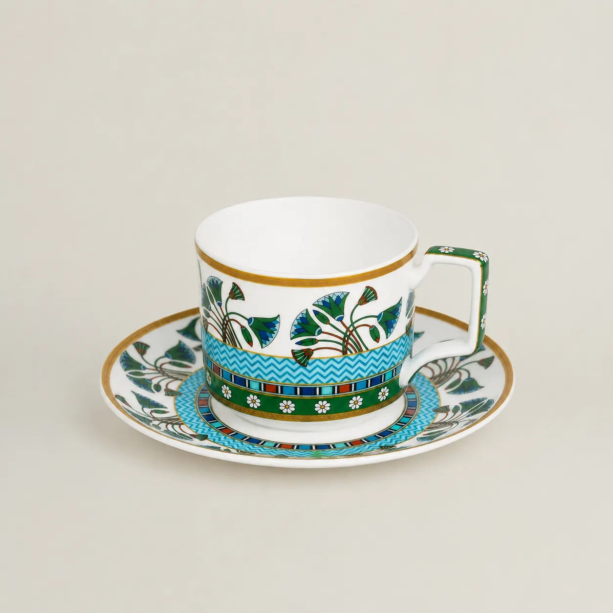 Luxury porcelain tea cup and saucer with blue-green floral detailing.