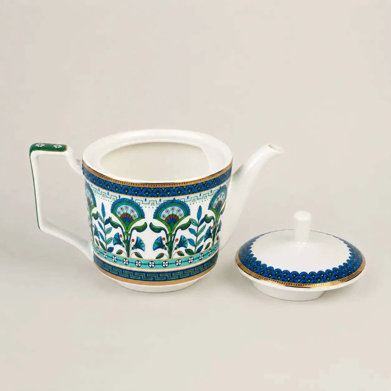 Elegant porcelain teapot with lid, floral motifs and gold accents.