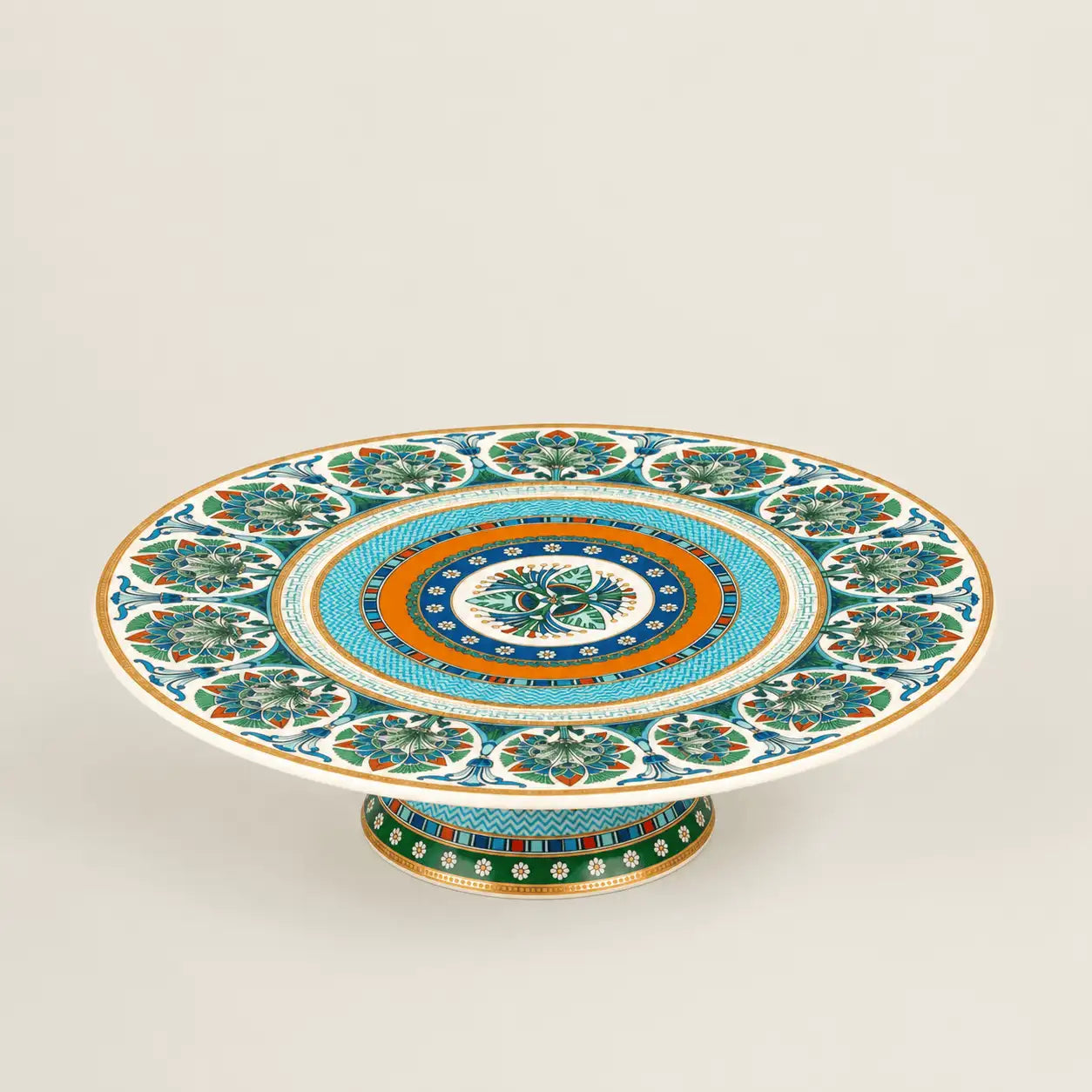 Luxury Mediterranean porcelain pedestal cake stand with intricate floral motifs and gold accents.