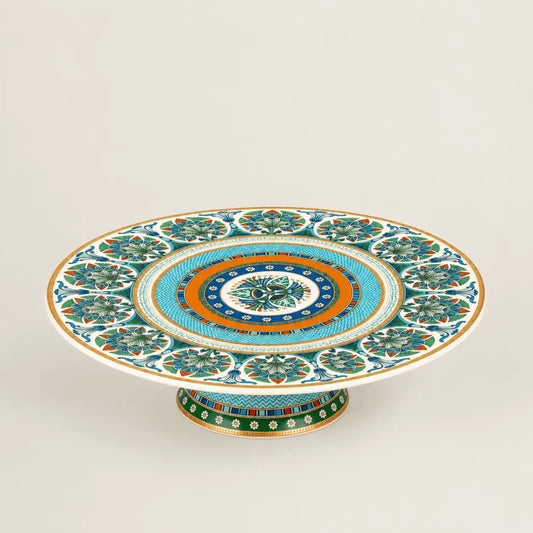 Luxury Mediterranean porcelain pedestal cake stand with intricate floral motifs and gold accents.