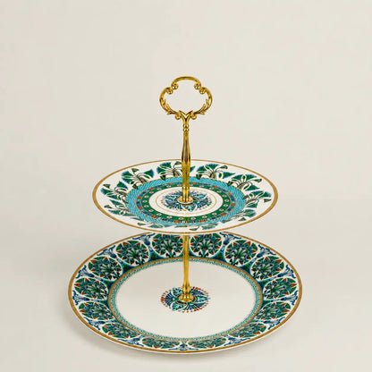 Luxury Mediterranean porcelain two-tier serving stand with gold handle and floral motifs.