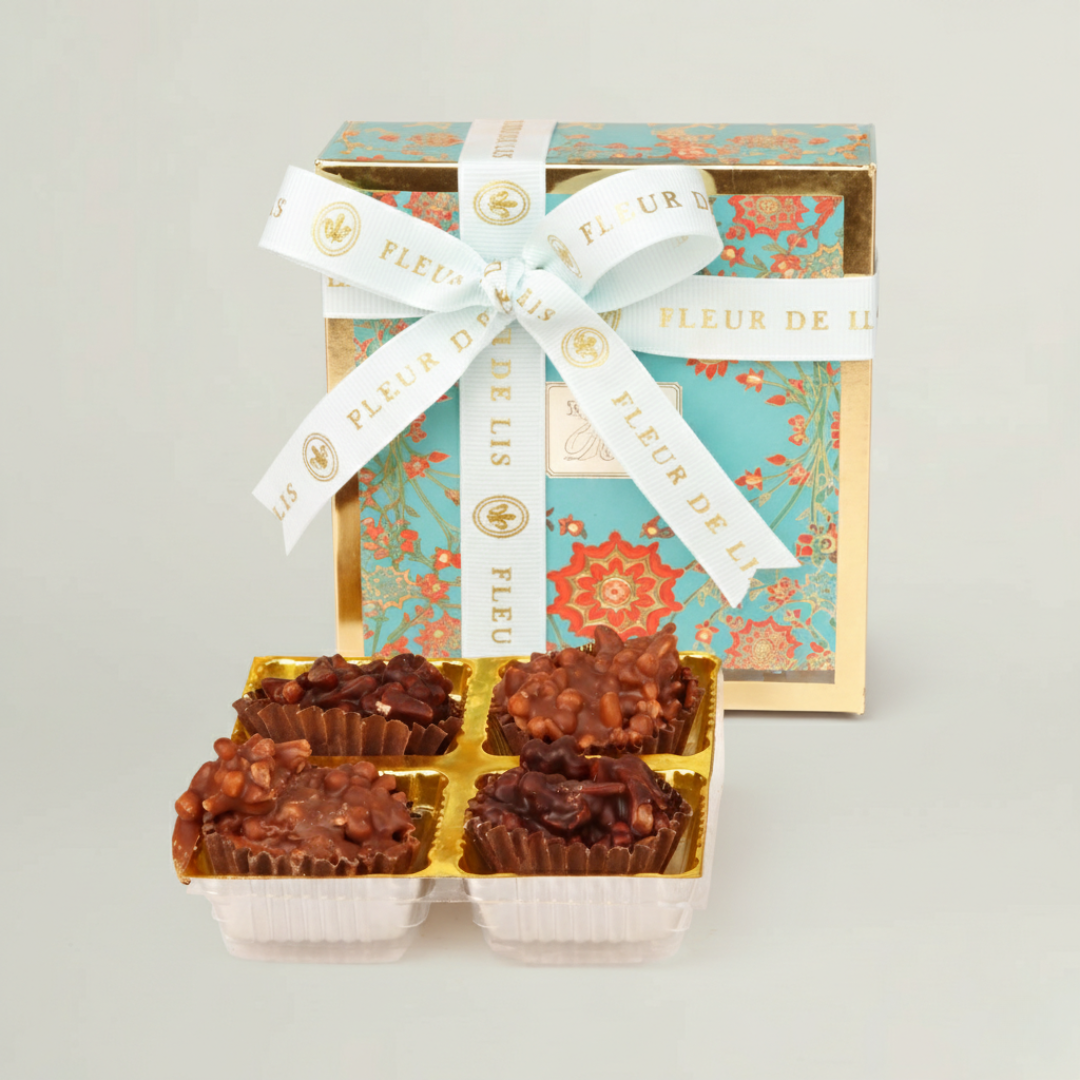 Premium assorted chocolates in decorative gift box included in luxury kids and newborn gift hamper.