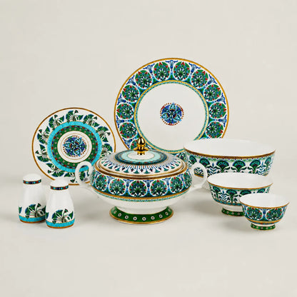 A complete luxury porcelain dinnerware collection including plates, bowls, shakers, and a tureen on a clean background.