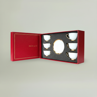 Six-piece ceramic coffee cup and saucer set with gold detailing, beautifully arranged in a premium Fleur de Lis gift box.